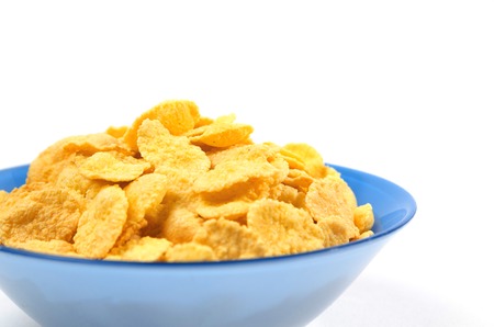 Blue bowl of cornflakes for breakfast on white background large