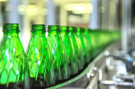 Closeup on mineral water green bottles in raw and linesの写真素材