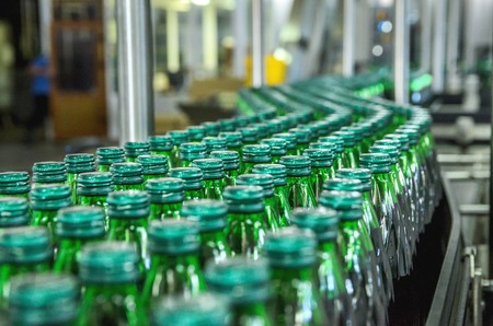 Closeup on mineral water green bottles in raw and linesの写真素材