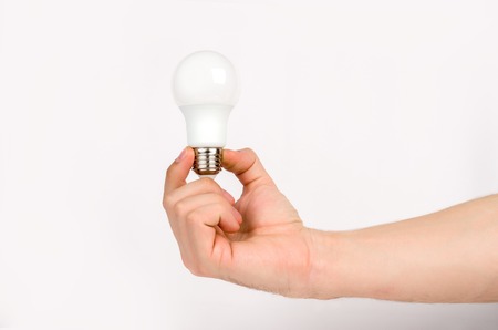 mans hand holding the LED lampの写真素材