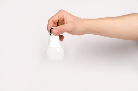 mans hand holding the LED lampの写真素材