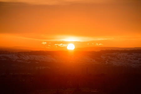 Sunset sky with the sun, with gold cloudsの写真素材