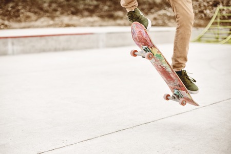 Close-up of skateboarders foot while skating in skate park