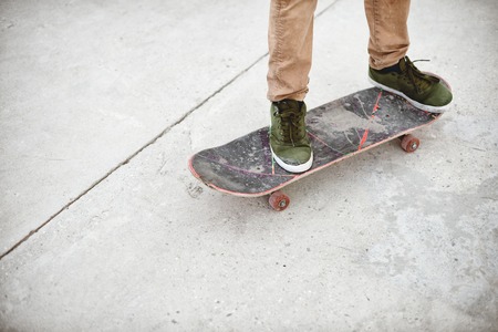 Close-up of skateboarders foot while skating in skate park