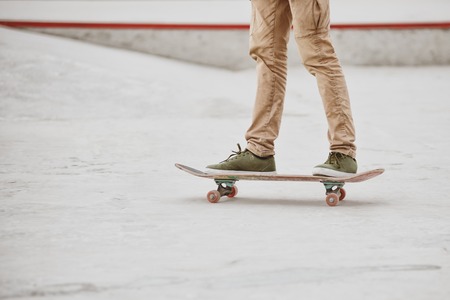 Close-up of skateboarders foot while skating in skate park