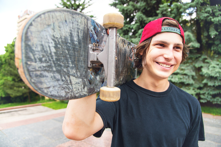 Portrait of a young skater with his favorite skateboardの写真素材