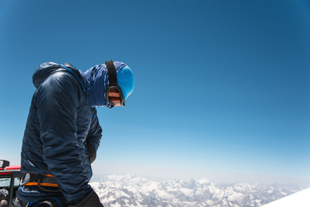 Professional guide - climber on the snow-covered summit of Elbrus sleeping volcanoの写真素材