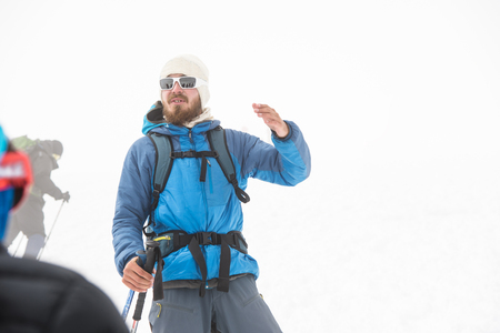 A team of climbers led by a guide discusses the upcoming ascentの写真素材