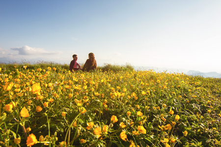 View from the back. Young married couple on picnic outdoorsの写真素材