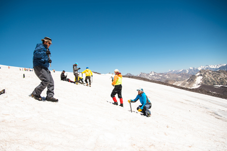 Learning to slip properly on a slope or glacier with an ice axの写真素材