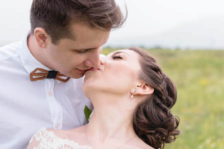 a couple of newlyweds standing in an arms embrace in natureの写真素材