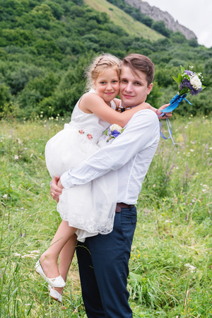 Portrait of a young father with his daughter in his armsの写真素材