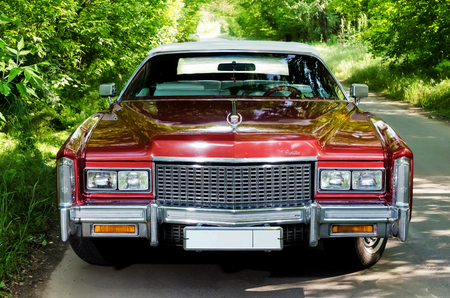 NEVINOMYSSC, RUSSIA - MAY 13, 2016: Automobiles. Offsite photography of old American cars. Cadillac Eldorado Convertible 1976s. Machine type from the front on a country road in a forestのeditorial素材