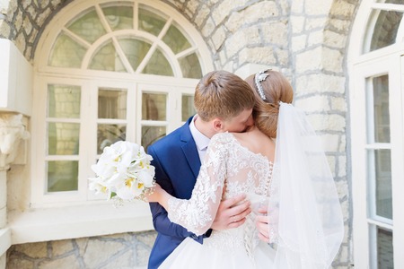 Portrait of a newlywed couple on a wedding walk. Concept of a happy young couple.の写真素材