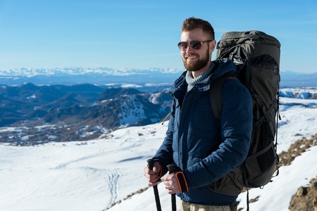 Portrait of a happy laughing Hipster traveler with a beard in sunglasses in the nature.の写真素材