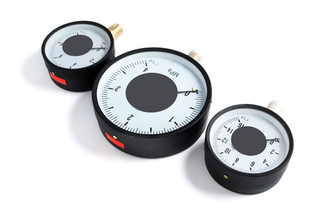 The pressure sensor in the pipeline is a manometer. Three gauges of different sizes on a white isolated backgroundの写真素材