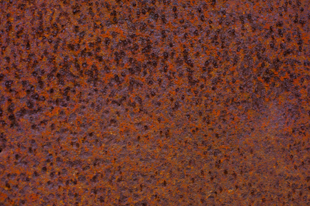 Rusty yellow-red textured metal surface. The texture of the metal sheet is prone to oxidation and...