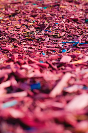 Textured background decorative colored sawdust for finishing flowerbeds in the winter season. Red and maroon sawdustの写真素材