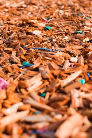 Textured background decorative colored sawdust for finishing flowerbeds in the winter season in outlook. orange, yellow sawdustの写真素材