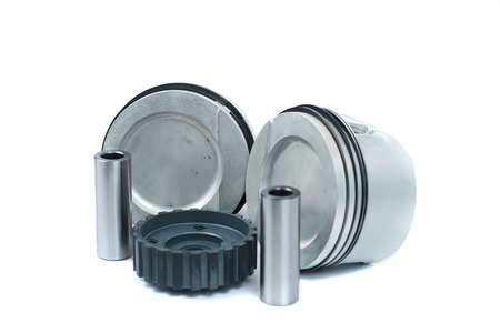 Close-up of spare parts two new pistons with connecting rods for a gasoline engine with installed...