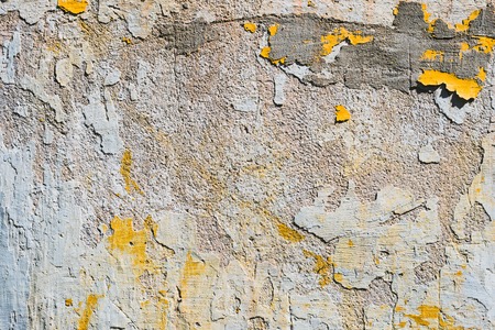 Textured grunge background. Volumetric plastered wall with a multilayer cracked coating. Orange...