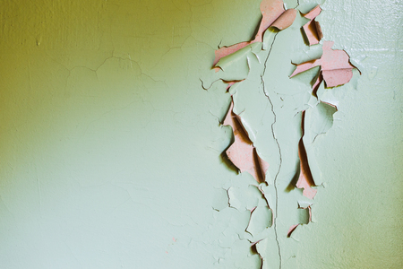 Grunge cracked wall paint peeling off. Yellow and cyanの写真素材