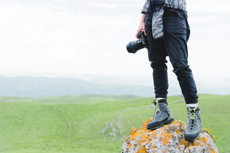 Photographer holding a camera outdoors. Girl on natureの写真素材