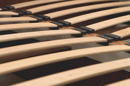 Close-up wooden elements of an arthopedic base of a double bed. Interior structure of furnitureの写真素材