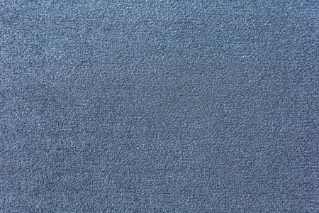 Texture of a dark blue carpet. Close-up of gradient lightの写真素材