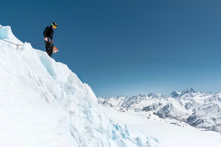 Mountain guide candidate training ice axe and rope skills on a glacier in the North Caucasusの写真素材
