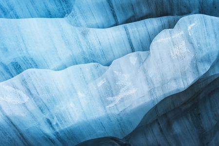 Close-up the ceiling of an ice grotto in a crumbling glacier. Textured background. Global warming. Small DOFの写真素材