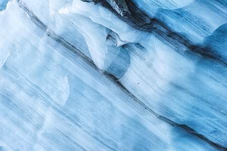 Close-up the ceiling of an ice grotto in a crumbling glacier. Textured background. Global warming. Small DOFの写真素材
