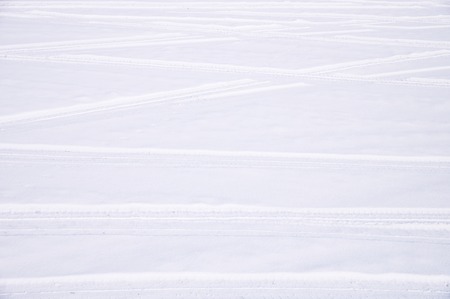Traces of intersecting arcs of automobile tires in fresh snow