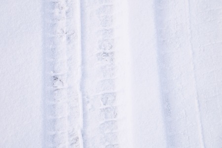 Traces of intersecting arcs of automobile tires in fresh snowの写真素材