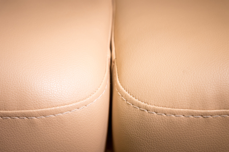 Close-up the Fragment of expensive beige leather sofa to indoorsの写真素材