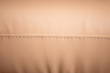 Close-up the Fragment of expensive beige leather sofa to indoorsの写真素材