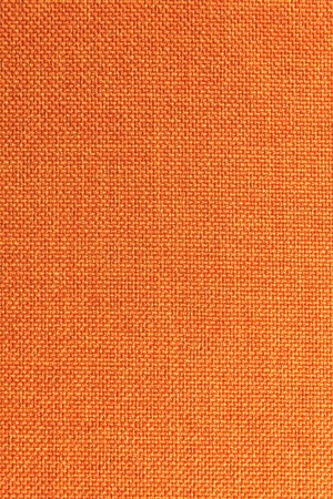 Textured background surface of textile upholstery furniture close-up. Orange color fabric structureの写真素材
