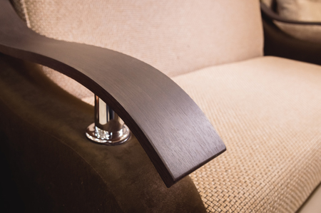 Close-up handle armrest textile beige sofa. New furniture. Shallow depth of field