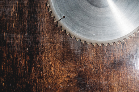 Close-up used blade circular saw on the background of the wooden table Verscak. Workshop for the production of wooden products. Joiners cutting toolの写真素材