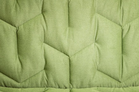 Close-up comfortable green soft sofa with curly stitching. Modern designの写真素材