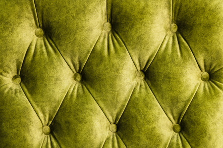 Velor lime surface of sofa close-up. Training equipment-velor mats tightened with buttons. Yellow chesterfield style quilted upholstery backgroundの写真素材