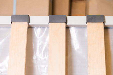 Close-up wooden elements of an arthopedic base of a double bed. Interior structure of furnitureの写真素材