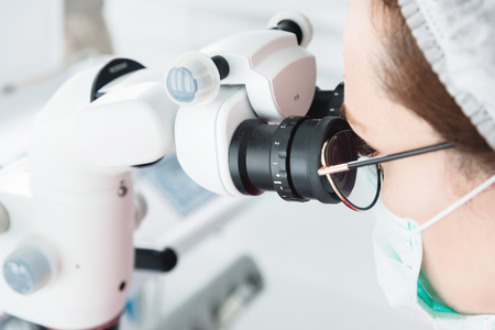 Close-up A woman in glasses with a professional dentist working with a professional stamotological...