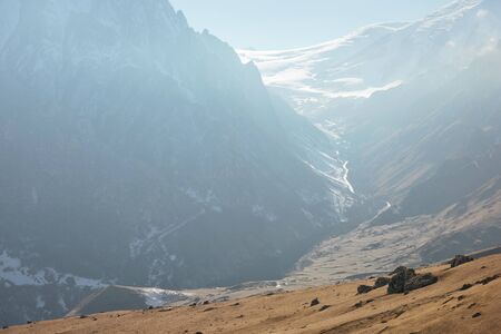 Mountain landscape of snowy mountain slopes and glaciers with approaching clouds in the Caucasus