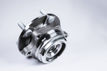New Wheel hub assembly with bearing. This is part of the car suspension on a gray background with a gradient. The concept of new car partsの写真素材