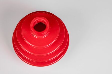 Red automobile axle boots or CV boots on grey gradient background.Spare parts for carsの写真素材