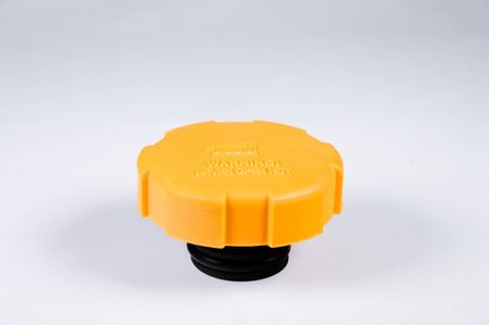 New car radiator valve cover on a gray background. The concept of new car parts