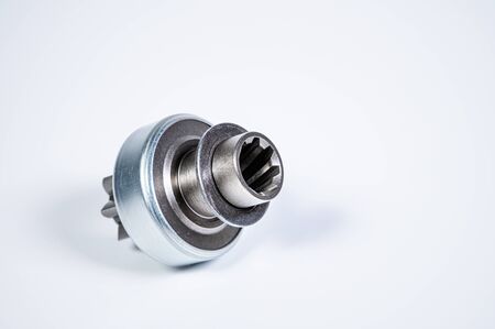 New spare parts - starter gear drive for motor starter on a gray background. Classic gear transmission via torque transmissionの写真素材