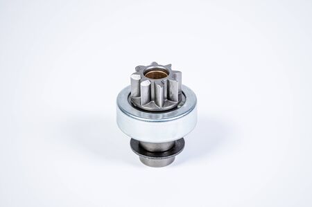 New spare parts - starter gear drive for motor starter on a gray background. Classic gear...