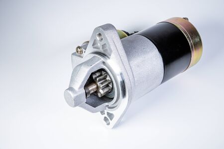 Starter of an internal combustion engine New Spare part for car on a gray backgroundの写真素材